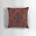 A decorative red and black throw pillow with a gothic, spooky pattern.