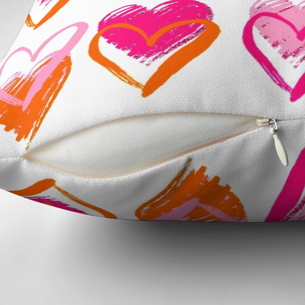 A decorative pink and orange heart-shaped pillow with a preppy, layered heart design.
