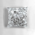 Artistic photographic image of mirrored and glass elements on a decorative accent pillow.