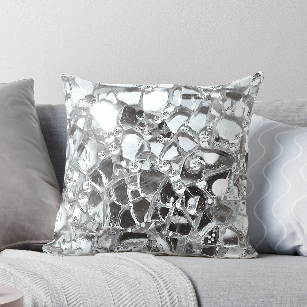 Artistic photographic image of mirrored and glass elements on a decorative accent pillow.
