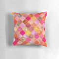 Decorative Moroccan tile pattern pillow in vibrant colors of hot pink, gold, tangerine, and taupe