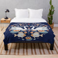 Plush blanket featuring a decorative ornament design with floral, folk art motifs including swans, hummingbirds, and water lilies