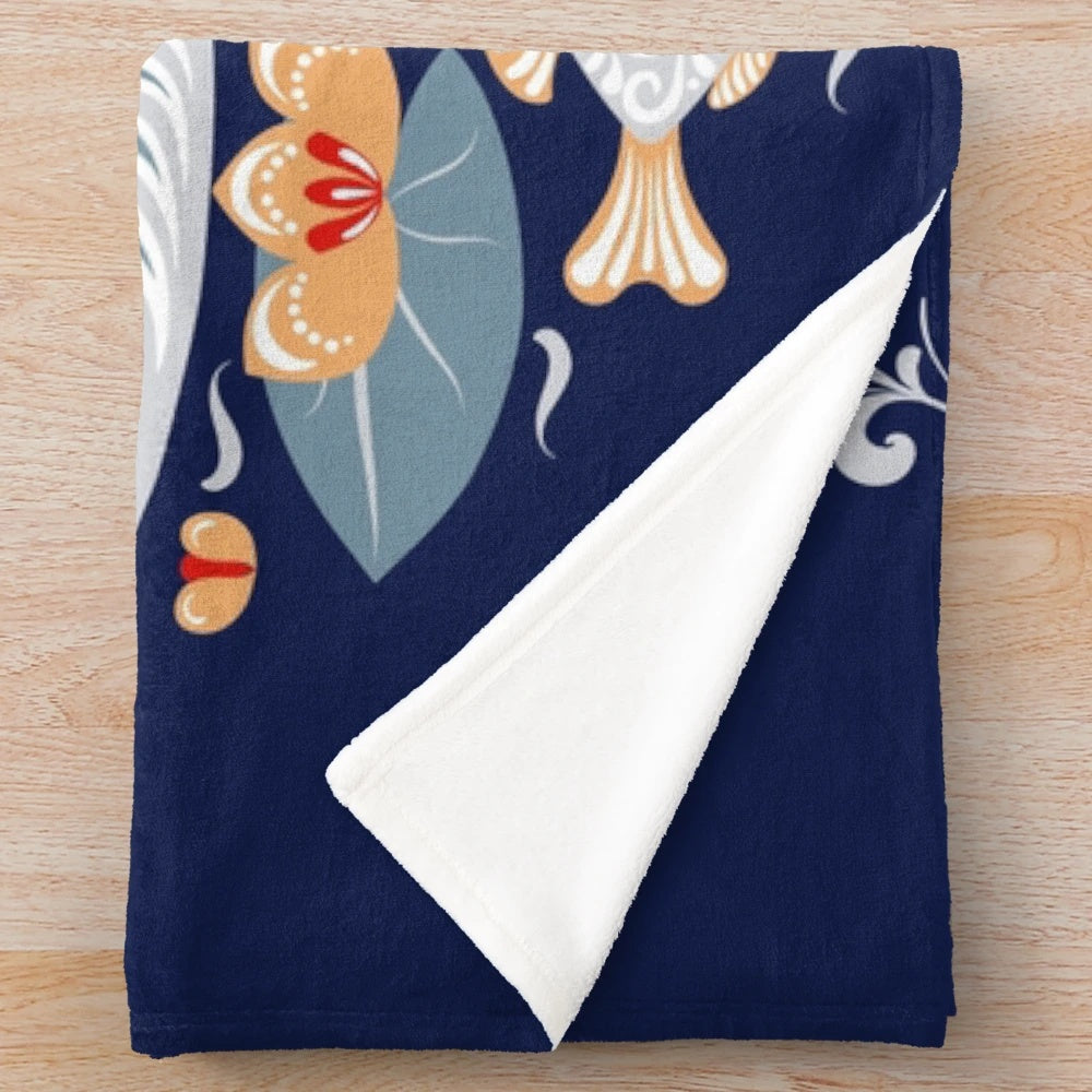 Plush blanket featuring a decorative ornament design with floral, folk art motifs including swans, hummingbirds, and water lilies
