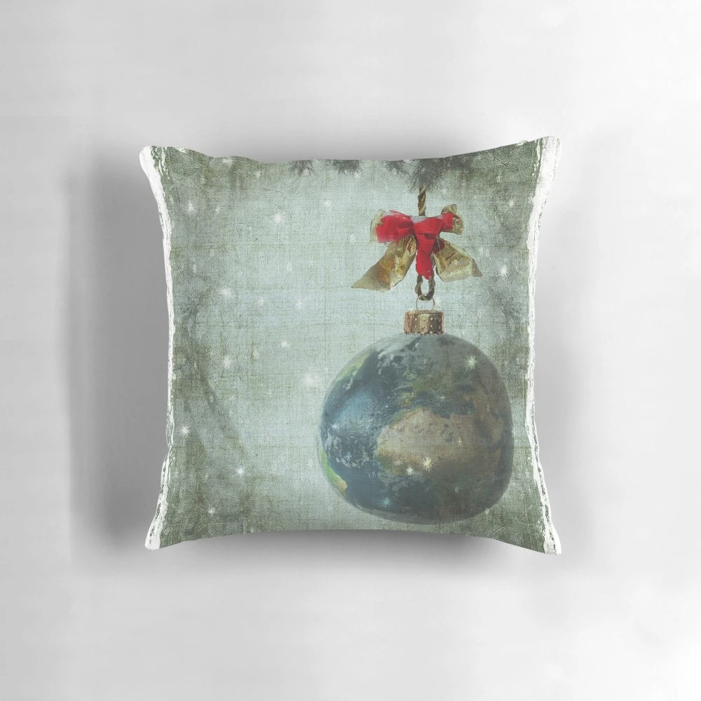 A white decorative pillow with a peace sign and the words "Peace on Earth" printed on it.