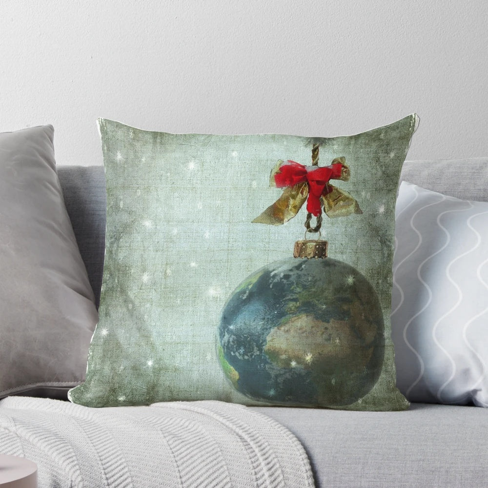 A white decorative pillow with a peace sign and the words "Peace on Earth" printed on it.