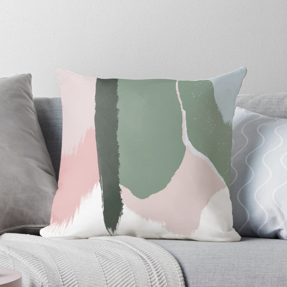 Decorative pillow with abstract art brush strokes in soft blush pink and sage green colors