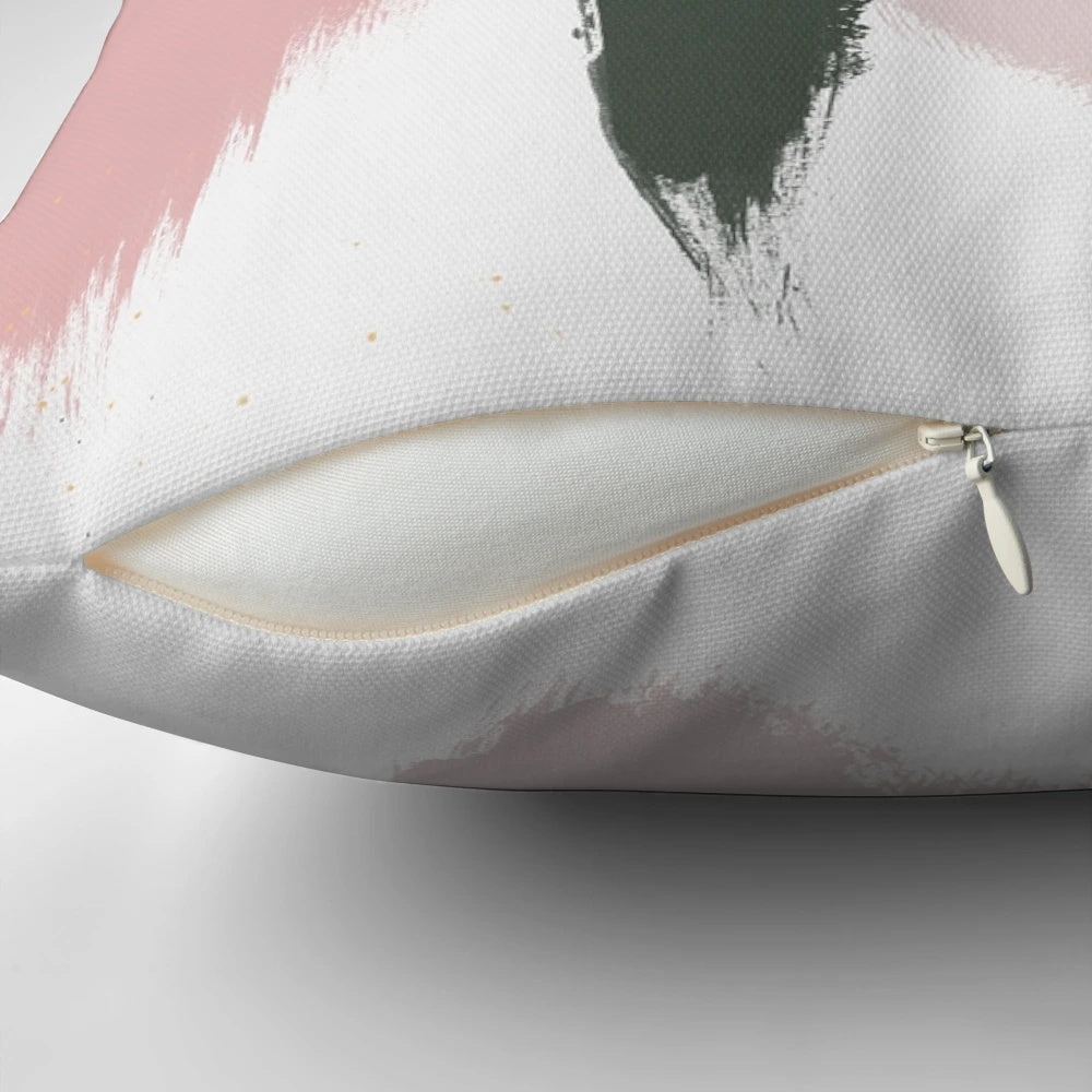 Decorative pillow with abstract art brush strokes in soft blush pink and sage green colors