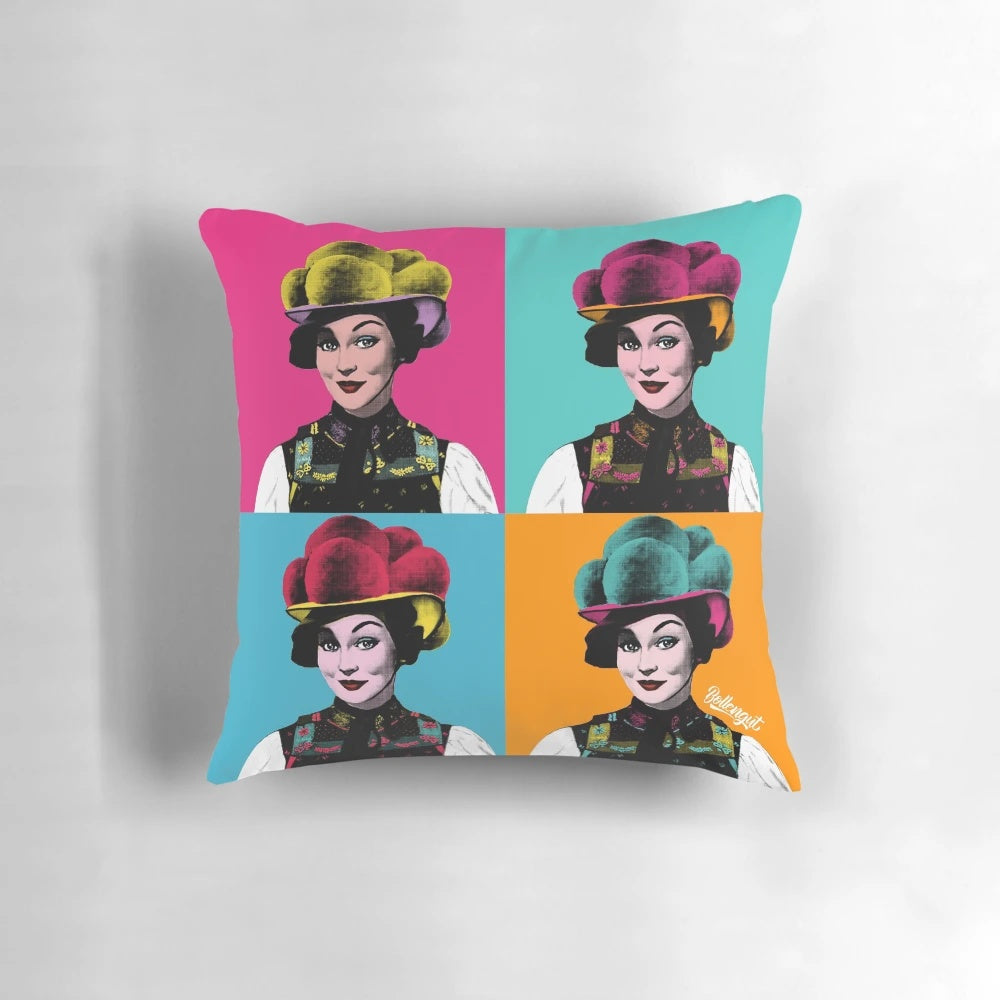 A decorative pillow featuring a pop art design of a Schwarzwaldmädel wearing a traditional Bollenhut from the Black Forest region.