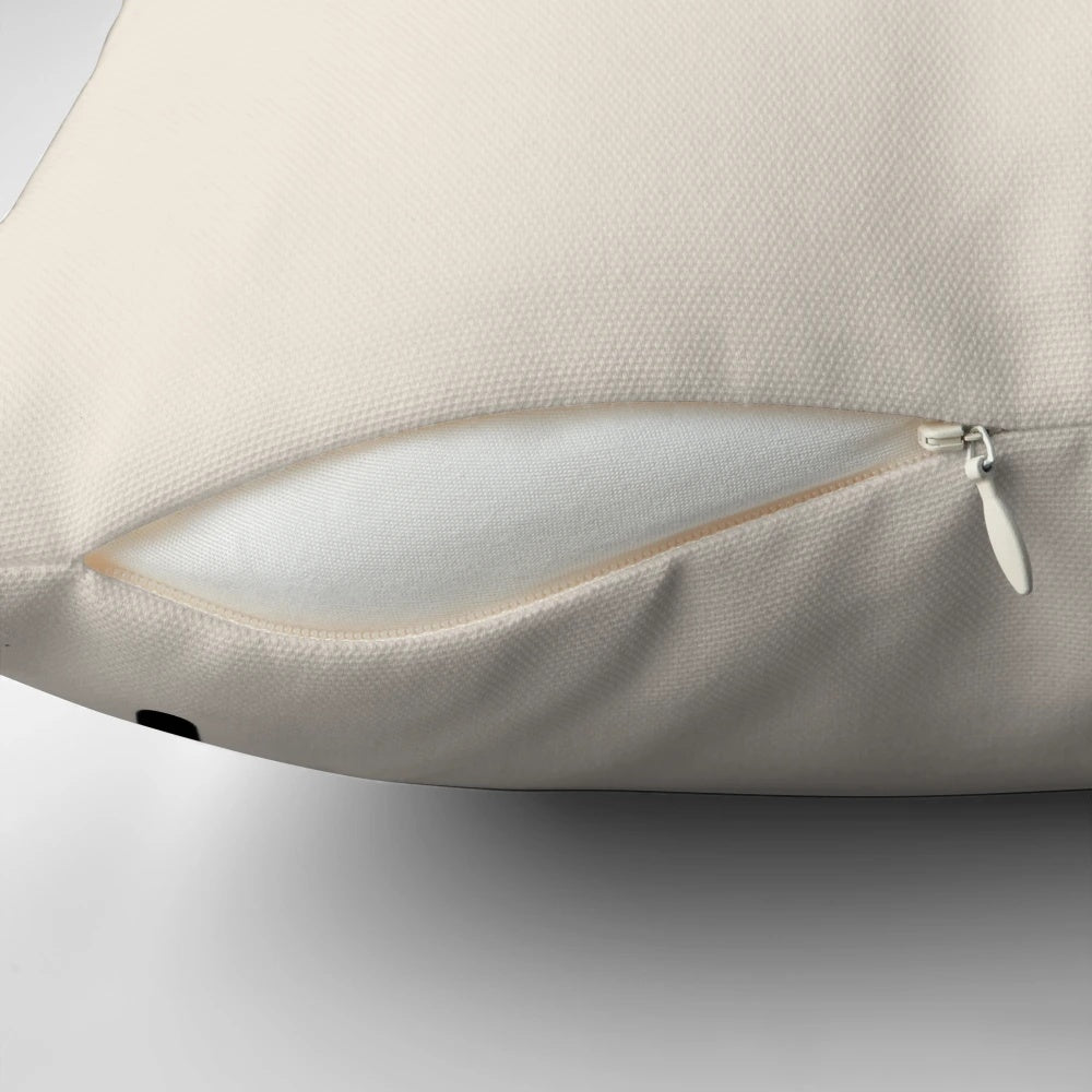 A decorative pillow featuring a stylized Scrabble letter 'S' in a modern, minimalist design.