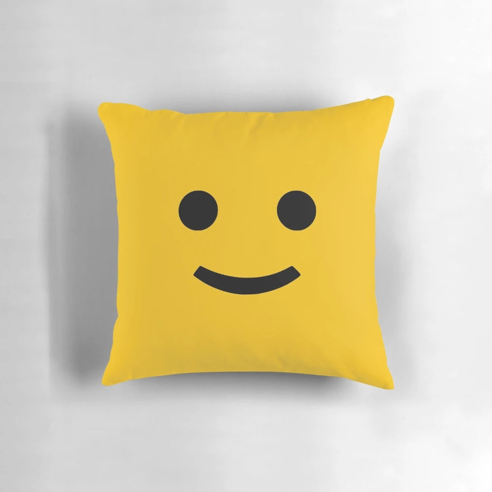 A cozy and cheerful decorative pillow with a happy smiley face design