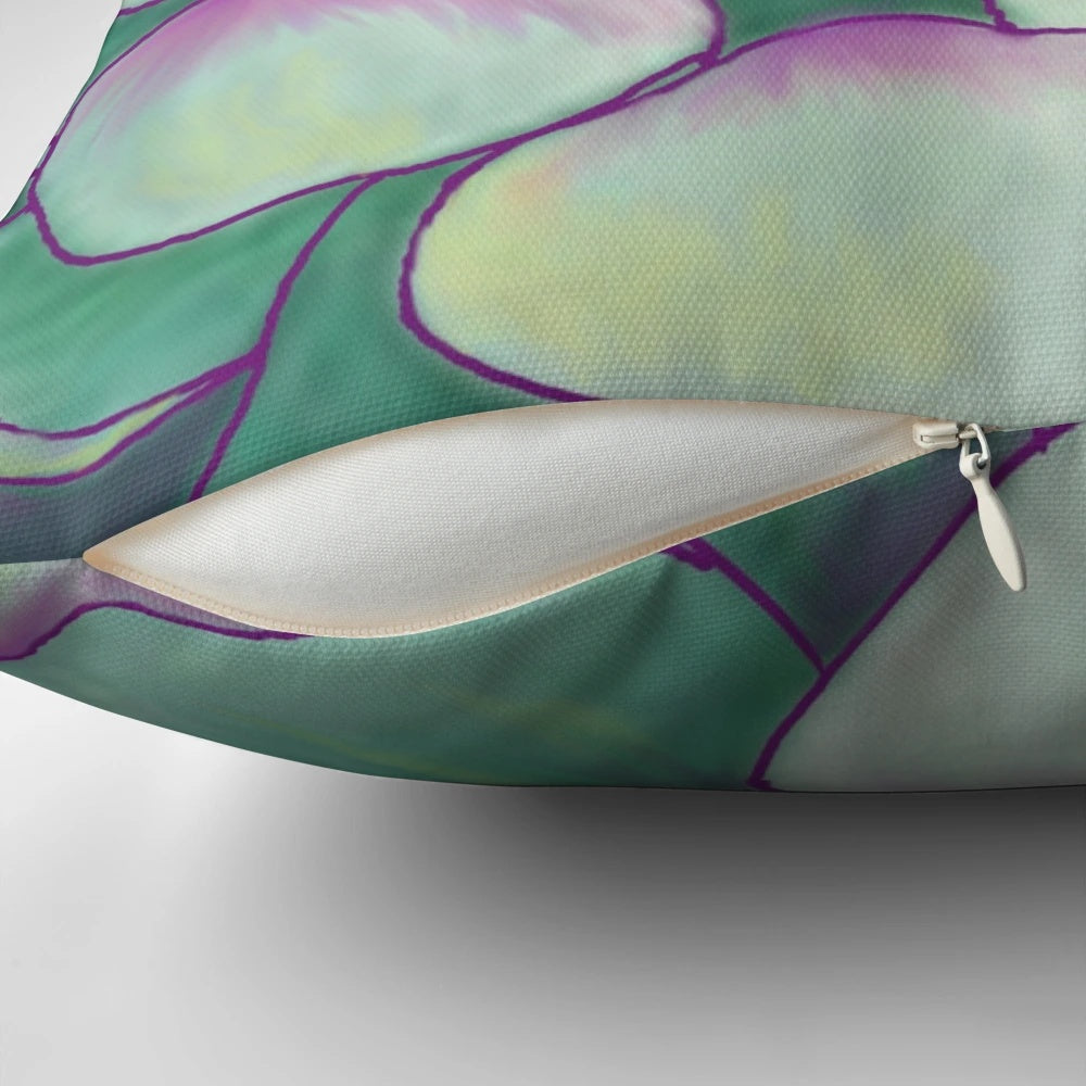 A close-up photograph of a decorative succulent plant pillow with vibrant green and purple colors.