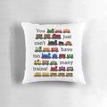 A black pillow with white text that reads "Too Many Trains", featuring a train-themed design.