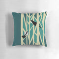 Throw pillow featuring a graphic design of tui and fantail birds perched on trees, a traditional New Zealand nature motif