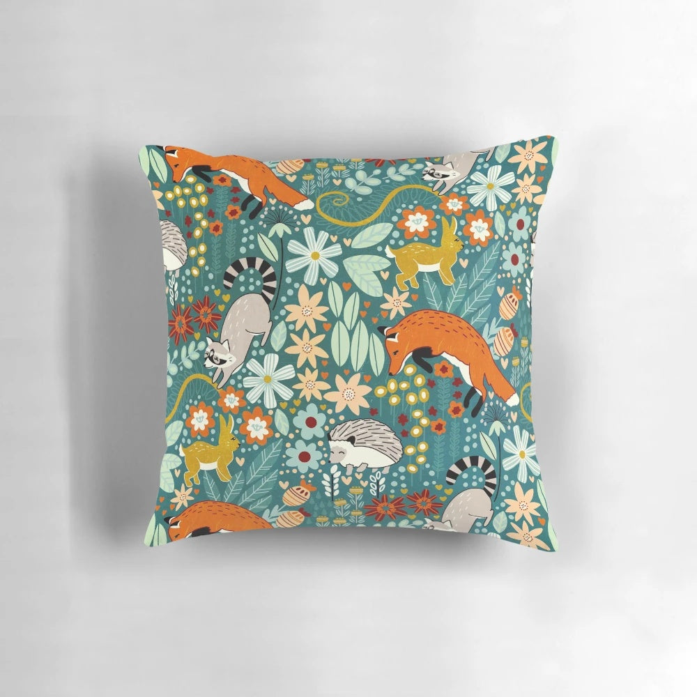 Decorative throw pillow featuring a whimsical woodland pattern with forest animals and floral elements, digitally illustrated in a hand-drawn style.
