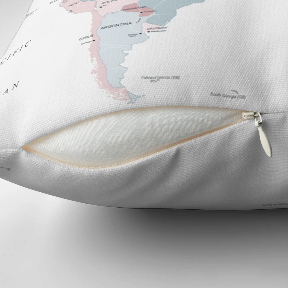 A decorative throw pillow featuring a detailed map of the world in soft pink and blue colors.