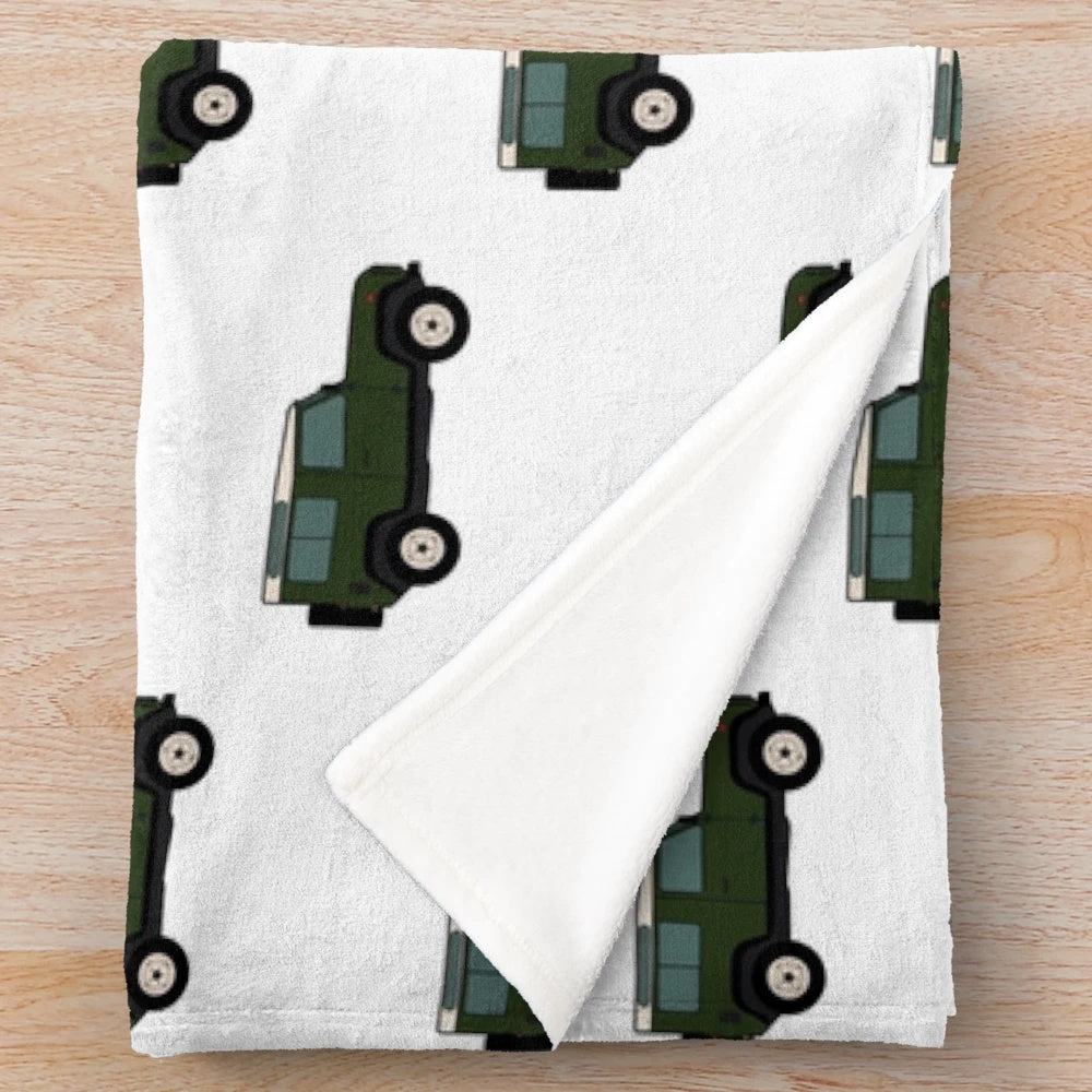 Defender-inspired green plush blanket featuring a classic off-road vehicle design