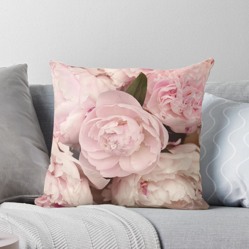 Close-up of soft, pink peony flowers printed on a decorative pillow