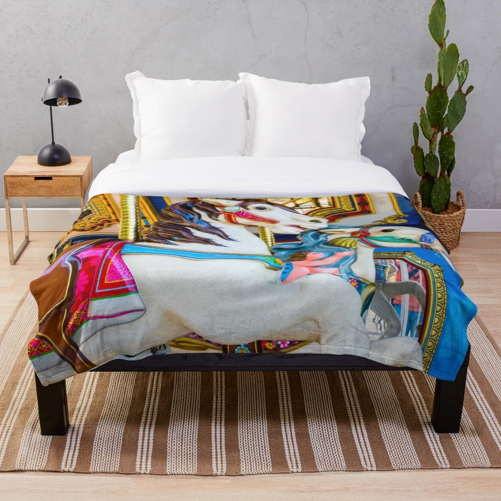 Colorful carousel horses design on a soft, plush blanket