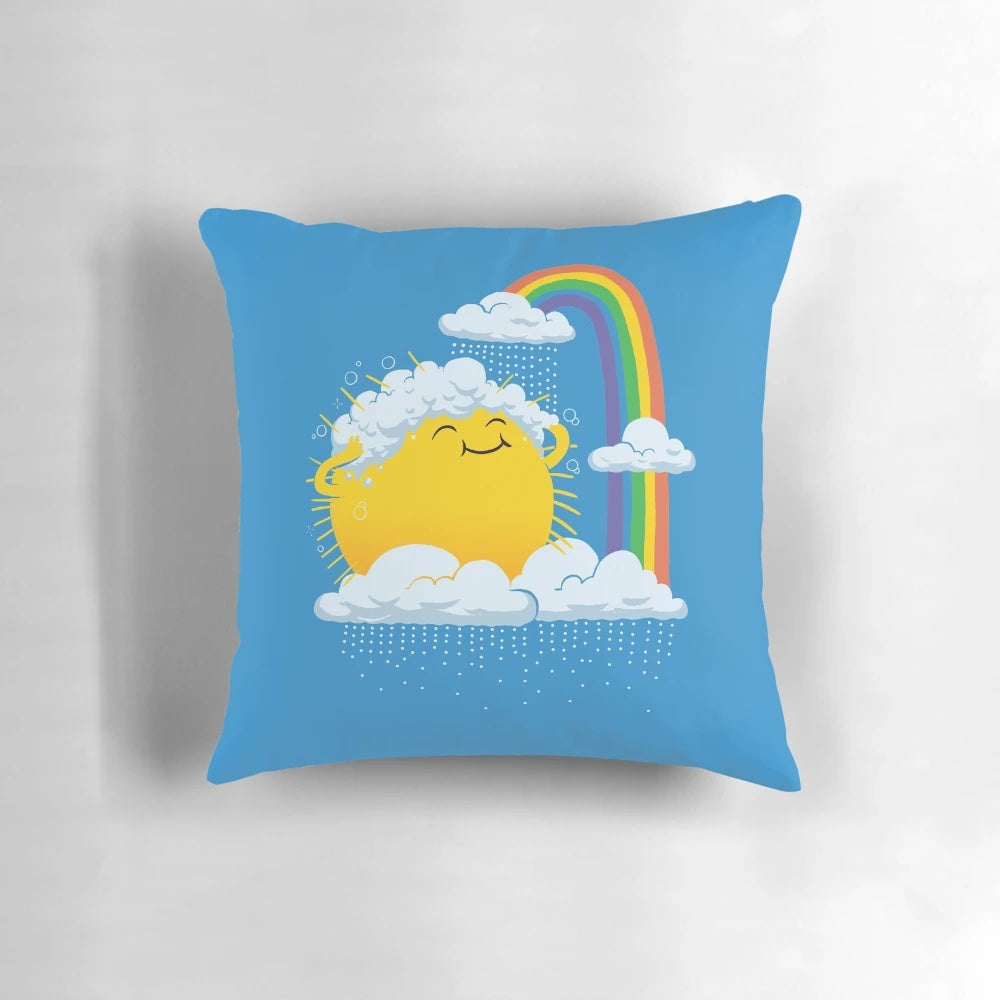 Whimsical illustration of a rainy day scene with a smiling sun, rainbow, and raindrops on a decorative kids pillow