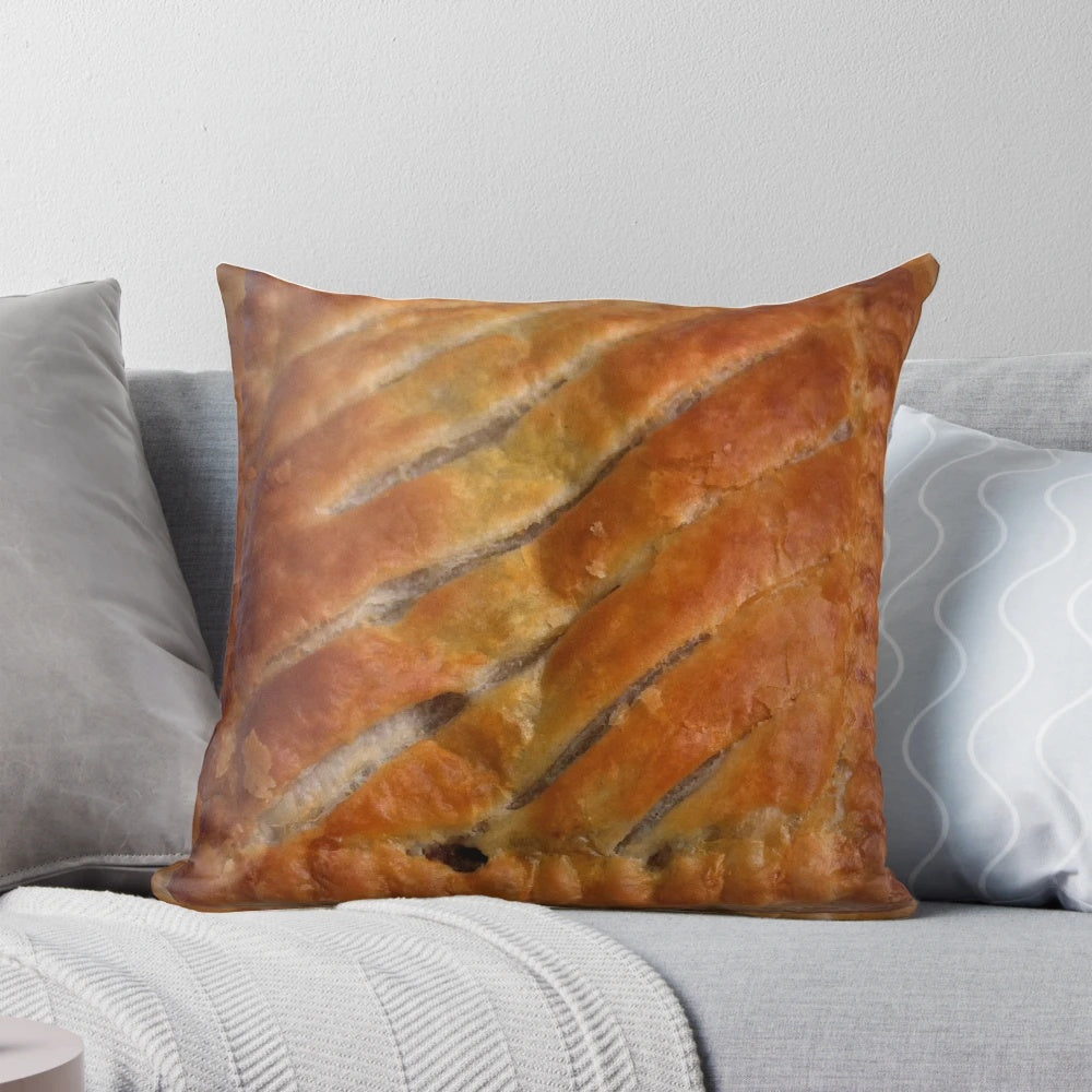 A cozy and whimsical pillow designed with a Greggs steak bake pattern, perfect for celebrating British cuisine.