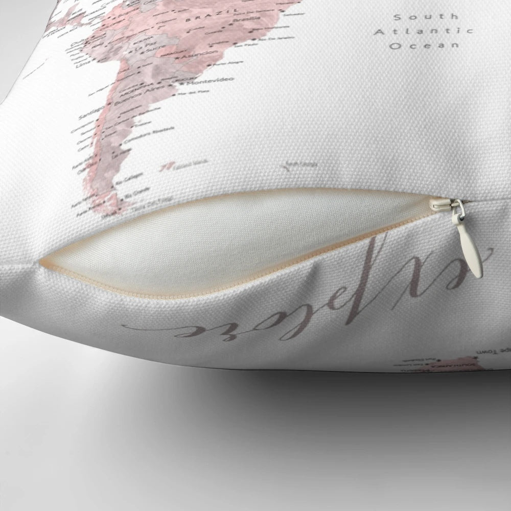 Detailed pink watercolor world map printed on a plush, decorative pillow