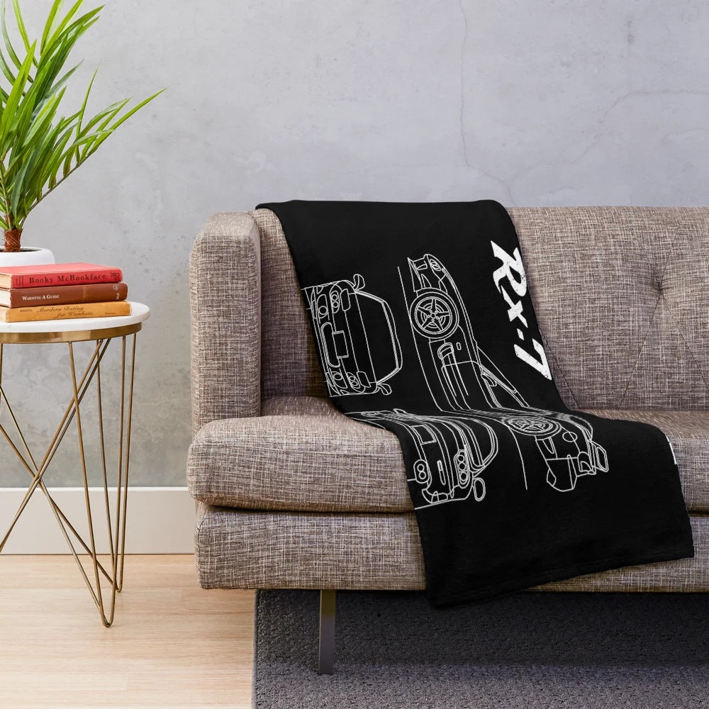 Detailed blueprint design of the Mazda RX7 on a plush blanket