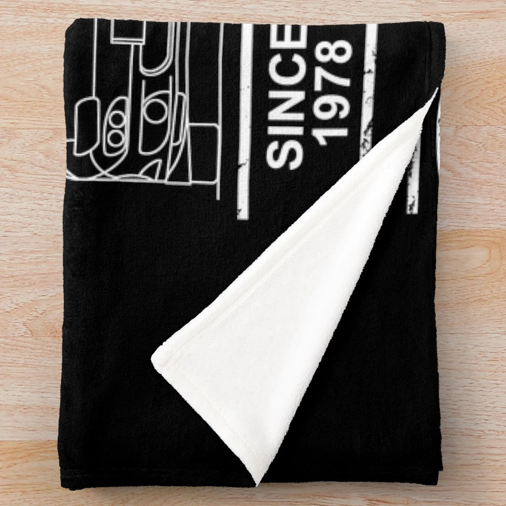 Detailed blueprint design of the Mazda RX7 on a plush blanket