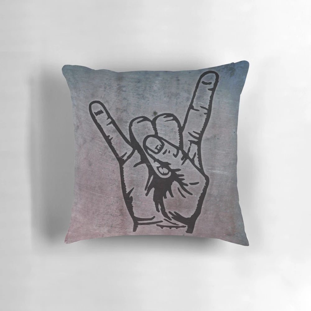 A decorative pillow with a stylized devil hand design in the shape of a french fry fork, featuring a pop art inspired graffiti-style pattern.