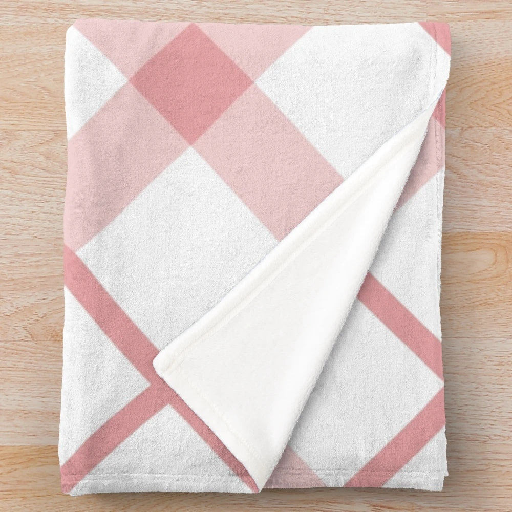 Diagonal plaid patterned plush blanket in pink