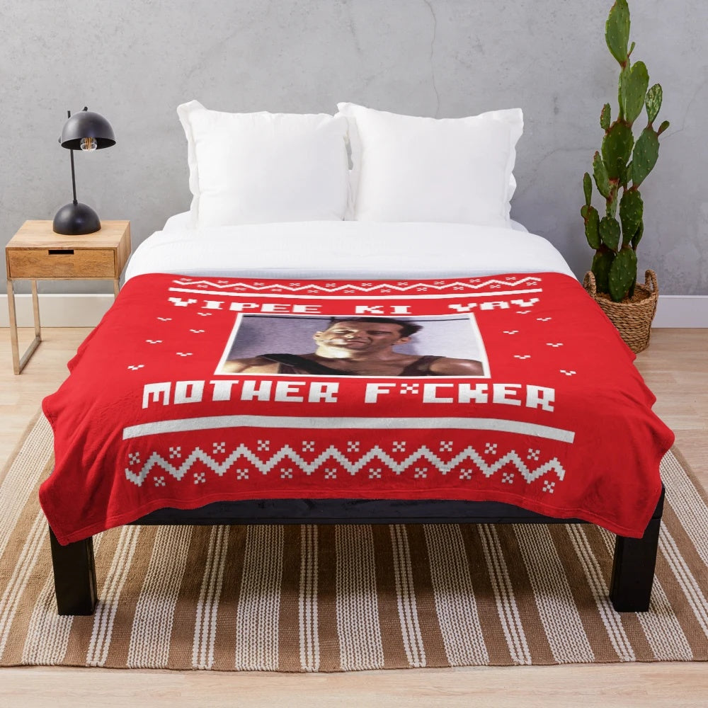 Die Hard-inspired plush blanket with "Yippee Ki Yay" text