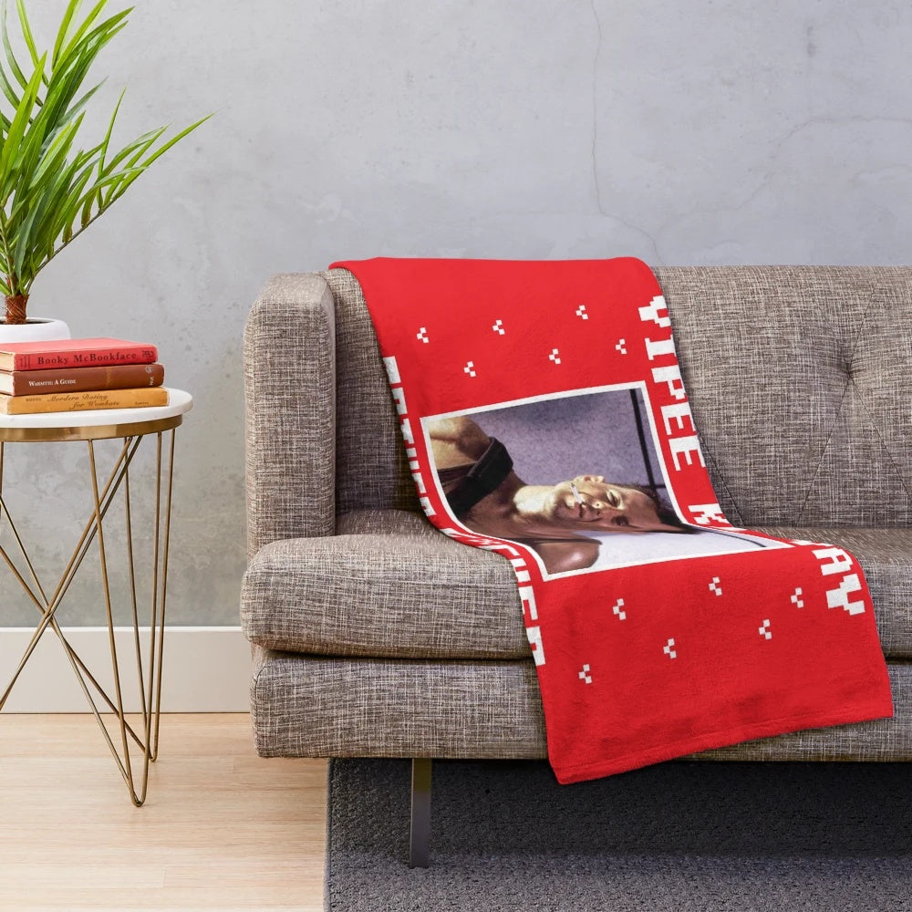 Die Hard-inspired plush blanket with "Yippee Ki Yay" text
