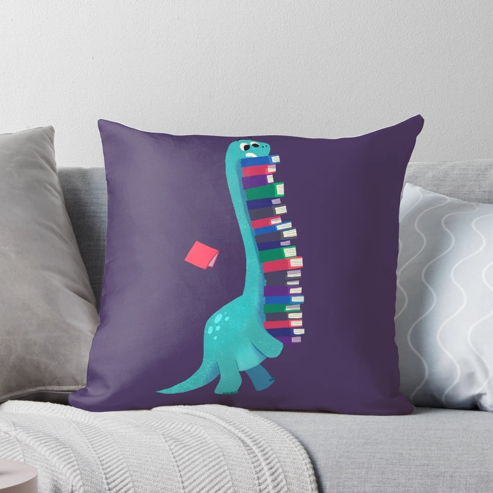 A soft, plush pillow featuring a dinosaur and book design, perfect for kids' rooms.