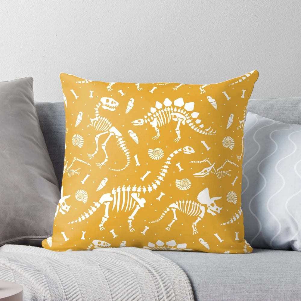 Mustard yellow pillow with dinosaur fossil design, ideal for dinosaur enthusiasts and paleontology fans.