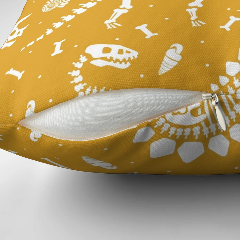 Mustard yellow pillow with dinosaur fossil design, ideal for dinosaur enthusiasts and paleontology fans.