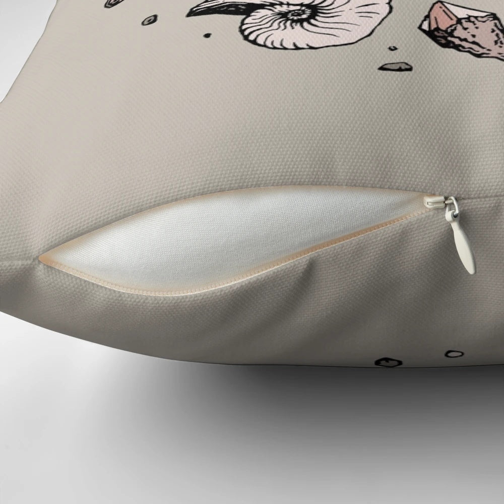 Pillow featuring a hand-drawn illustration of a dinosaur skull fossil, including a tyrannosaurus rex bone structure and rose quartz mineral.
