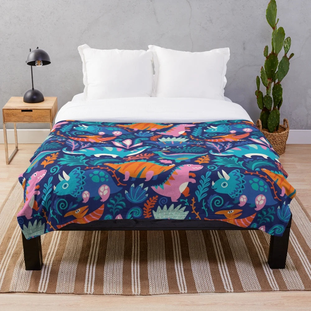 A soft and cozy plush blanket featuring a dinosaur-themed design
