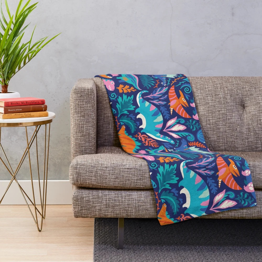 A soft and cozy plush blanket featuring a dinosaur-themed design