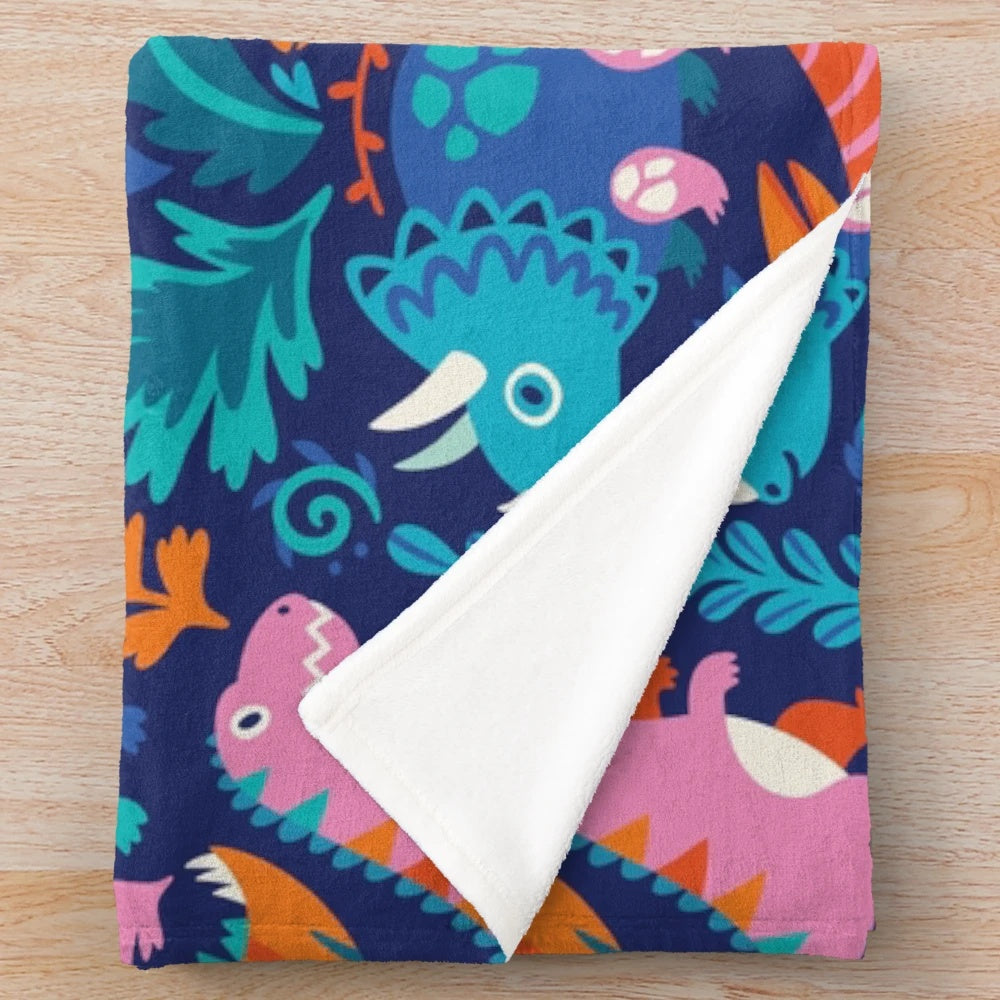 A soft and cozy plush blanket featuring a dinosaur-themed design