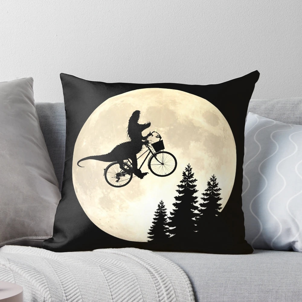 A close-up image of a colorful and whimsical pillow featuring a dinosaur, bicycle, and alien motif.
