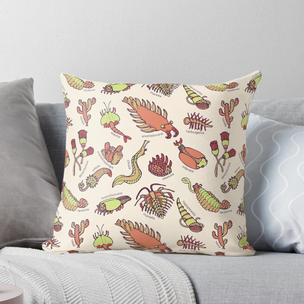 Colorful throw pillow featuring an infographic-style illustration of various Cambrian period invertebrate fossils