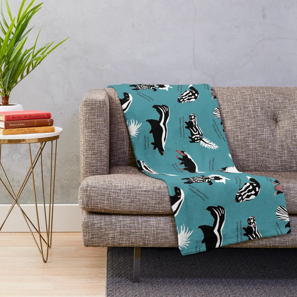 Plush blanket featuring various skunk species from the Mephitidae family