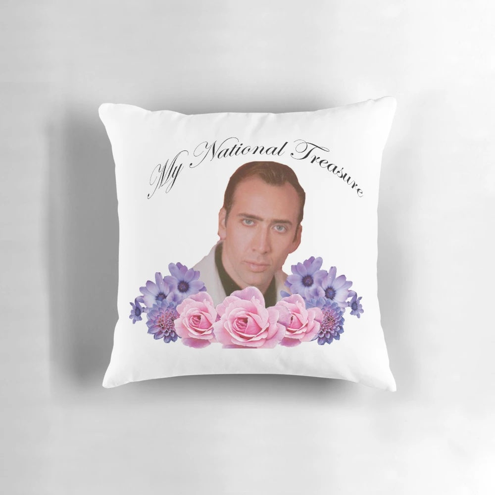 A stylish floral pillow featuring the iconic face of Nicholas Cage, the star of National Treasure.