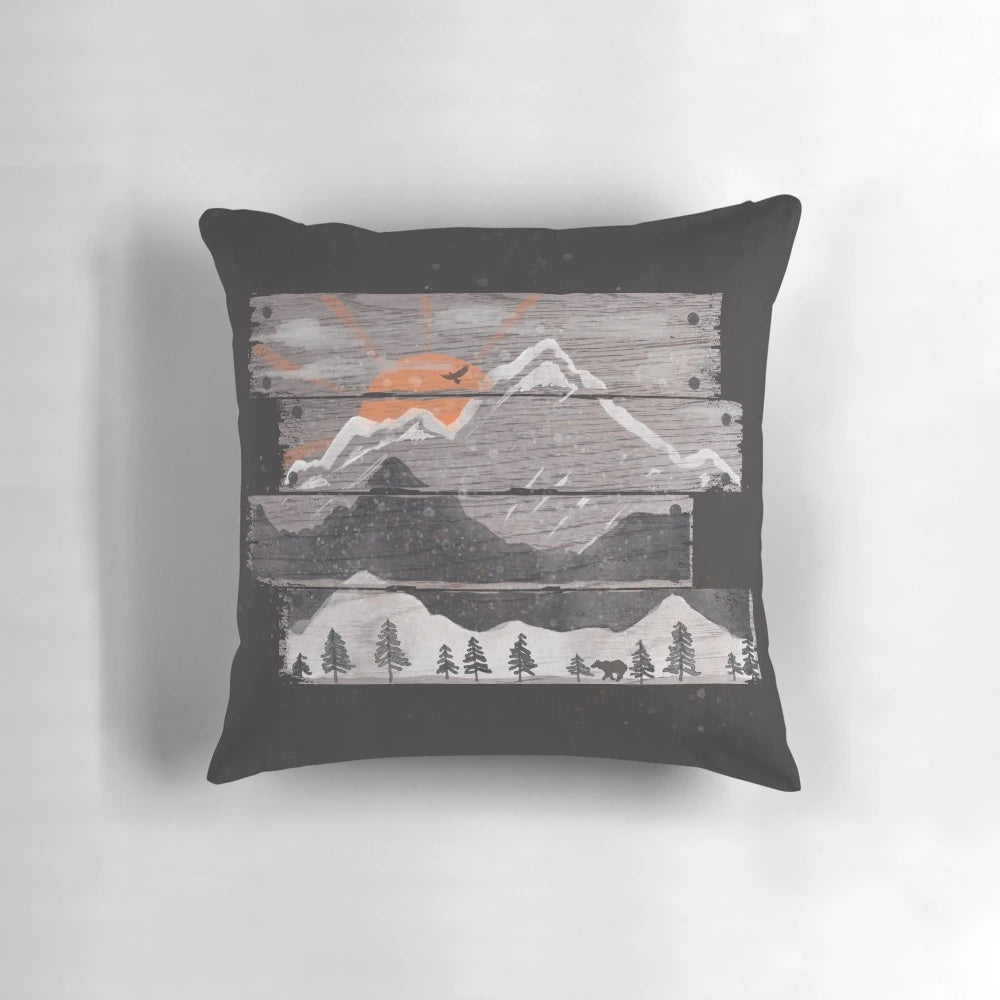 Cozy grey pillow with nature-inspired design featuring mountains, sunset, and wildlife