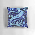A decorative pillow featuring vibrant illustrations of deep sea creatures like anglerfish, jellyfish, and squid.