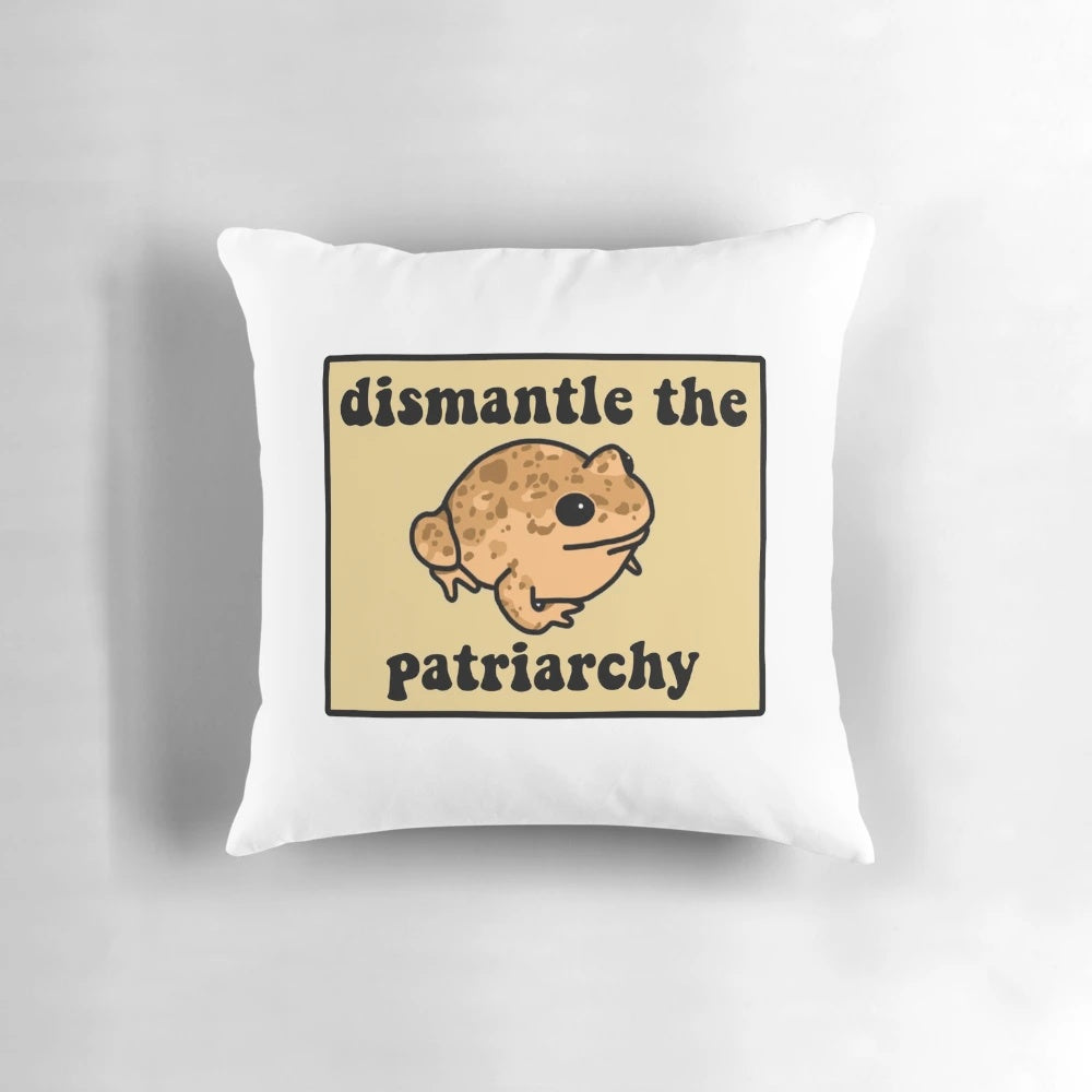 Beige frog pillow with speckled patterns, showcasing a message to dismantle the patriarchy.