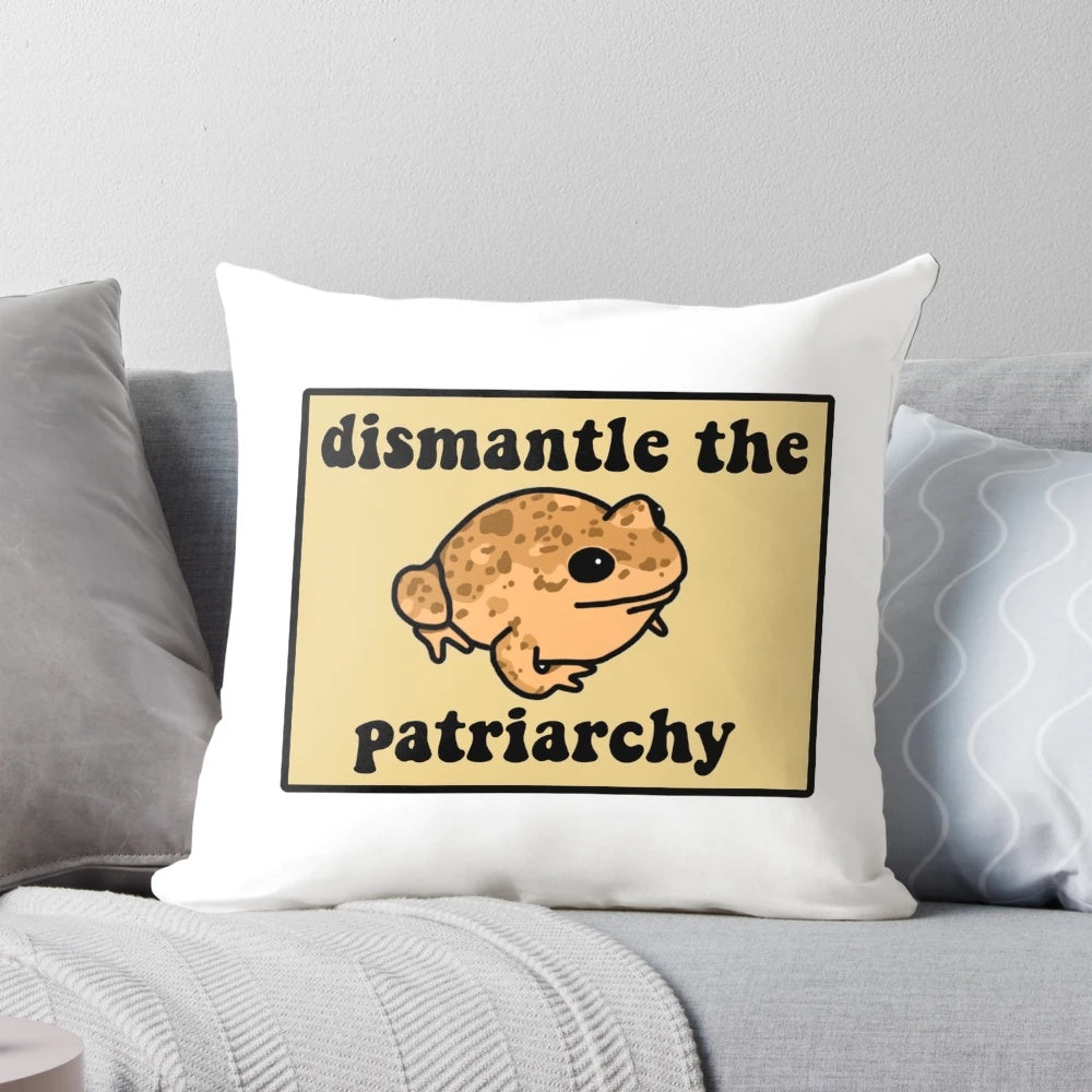 Beige frog pillow with speckled patterns, showcasing a message to dismantle the patriarchy.