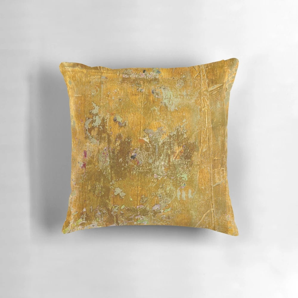 Worn, abstract pattern pillow in ochre and yellow colors with a distressed, aged texture.