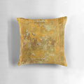 Worn, abstract pattern pillow in ochre and yellow colors with a distressed, aged texture.