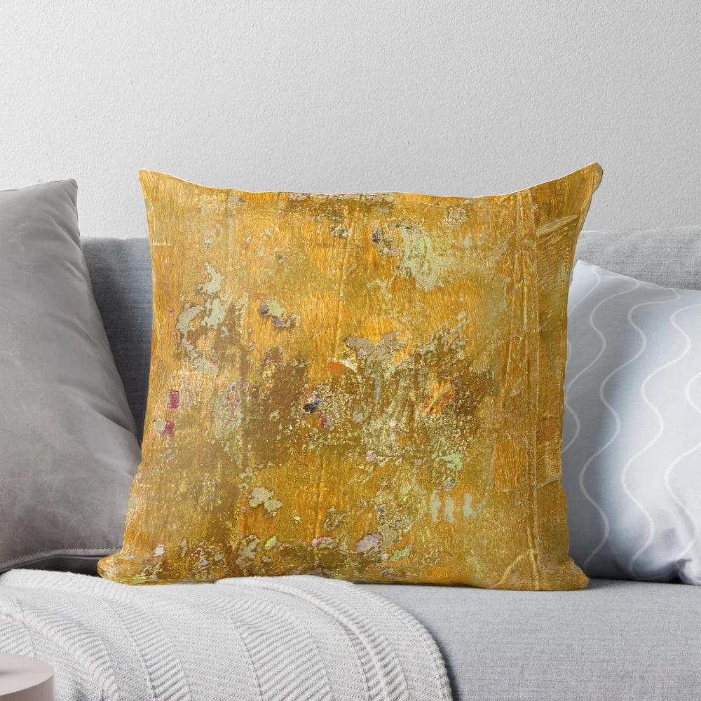 Worn, abstract pattern pillow in ochre and yellow colors with a distressed, aged texture.
