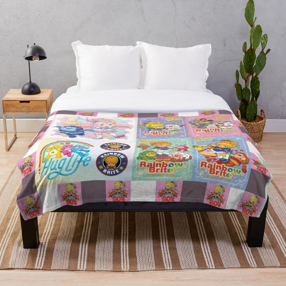 Distressed vintage plush blanket featuring a collage of retro Rainbow Brite and Strawberry Shortcake characters